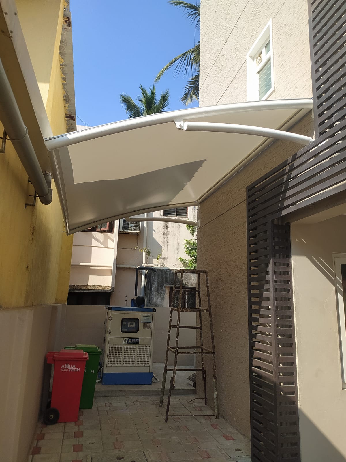 White tensile canopy walkway installed for commercial building entrance by Arasuvel Roofings in Chennai