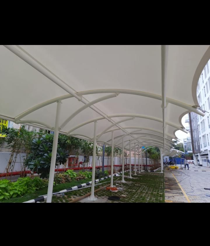 White tensile canopy installed over a commercial walkway with MS steel structure in Chennai